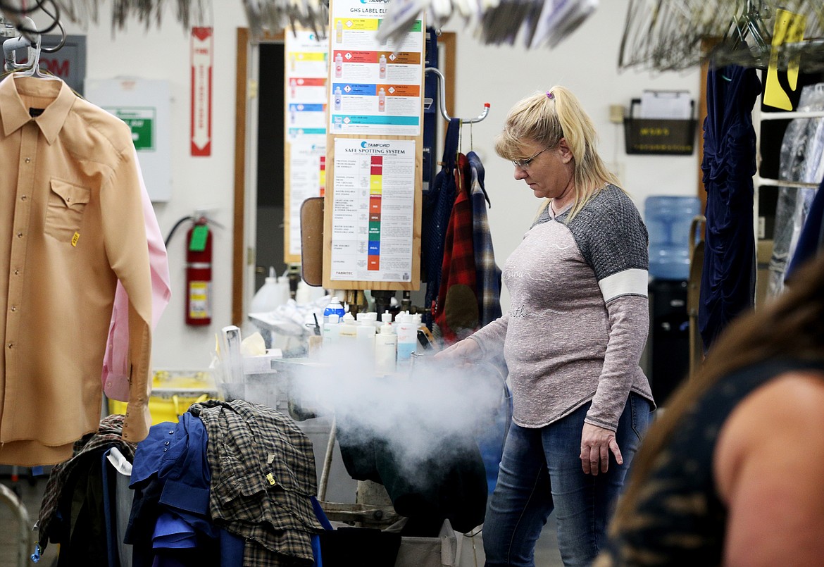 Photos by LOREN BENOIT/BJNI
Tammy Brewer uses a steamer to clean a pair of men&#146;s pants.