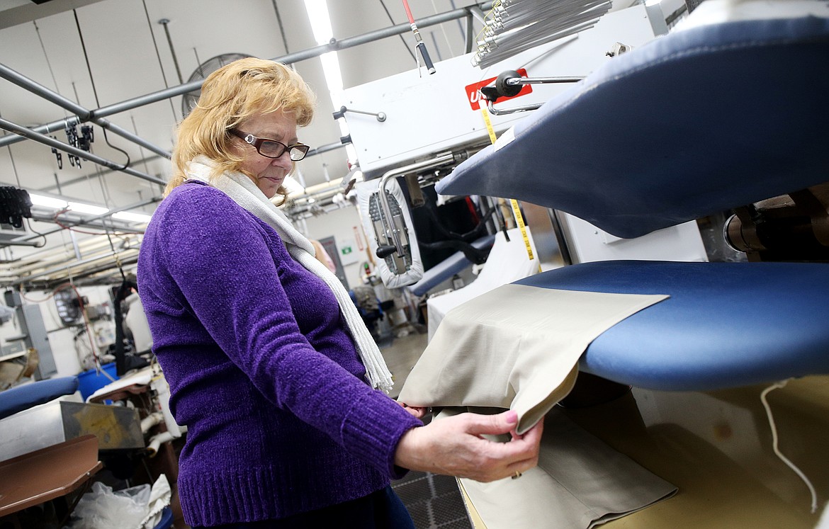 LOREN BENOIT/BJNI
Doris Todd irons dress pants for a customer at Country Cleaners.