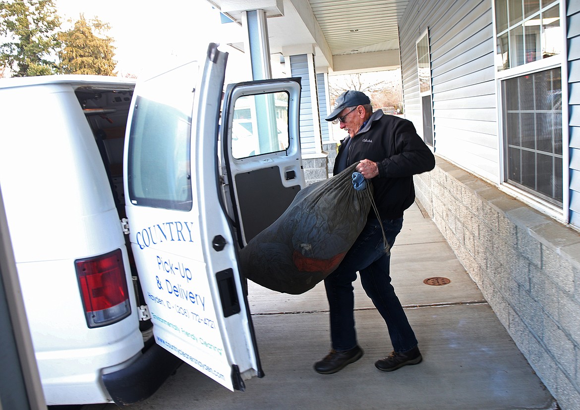 Country Cleaners employee Mike Haenke unloads laundry from his delivery truck. Country Cleaners has full laundry service for bed sheets, clothes, tablecloths, and other fine linens.
