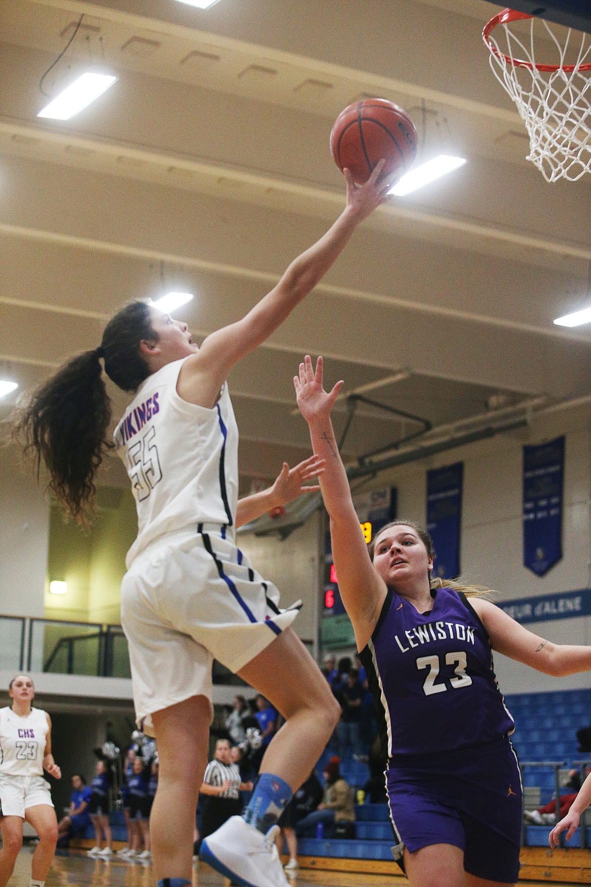 Coeur d&#146;Alene&#146;s Skylar Burke goes for a layup in front of Lewiston&#146;s Caitlin Richardson Friday night at Viking Court. (LOREN BENOIT/Press)