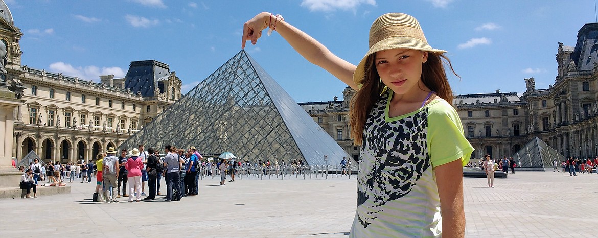 Becca McLachlan of Coeur d&#146;Alene has the world at her fingertips in May 2017 while visiting the Louvre Museum in Paris during a yearlong family trip around the globe. Becca and her brother, Jamey, and parents, Nicola and Evan, traveled to nine countries in 372 days for about $113 a day. Evan just released a book, &#147;How to See the World: A Budget Friendly Guide for Families&#148; that he will be reading from Saturday at the Art Spirit Gallery in Coeur d&#146;Alene.