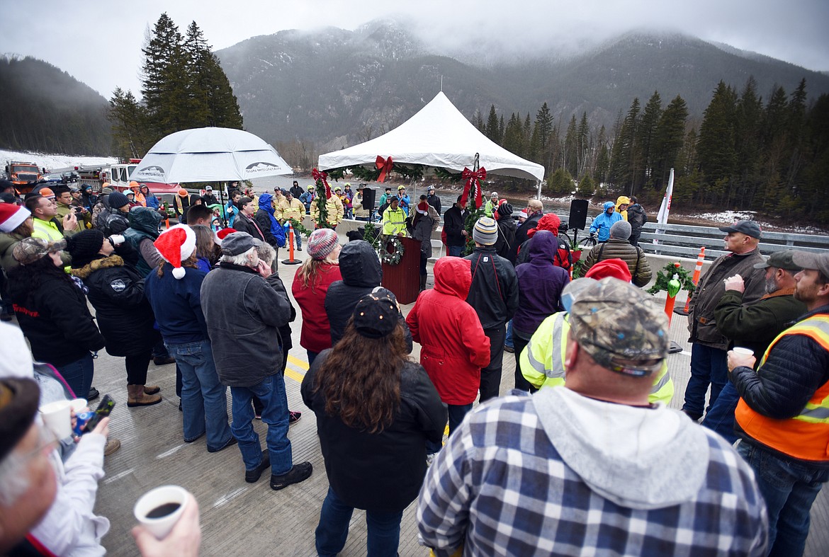 A large crowded gathered in the rain for the South Fork Bridge Ribbon-Cutting on Tuesday, December 18, in Hungry Horse.(Brenda Ahearn/Daily Inter Lake)