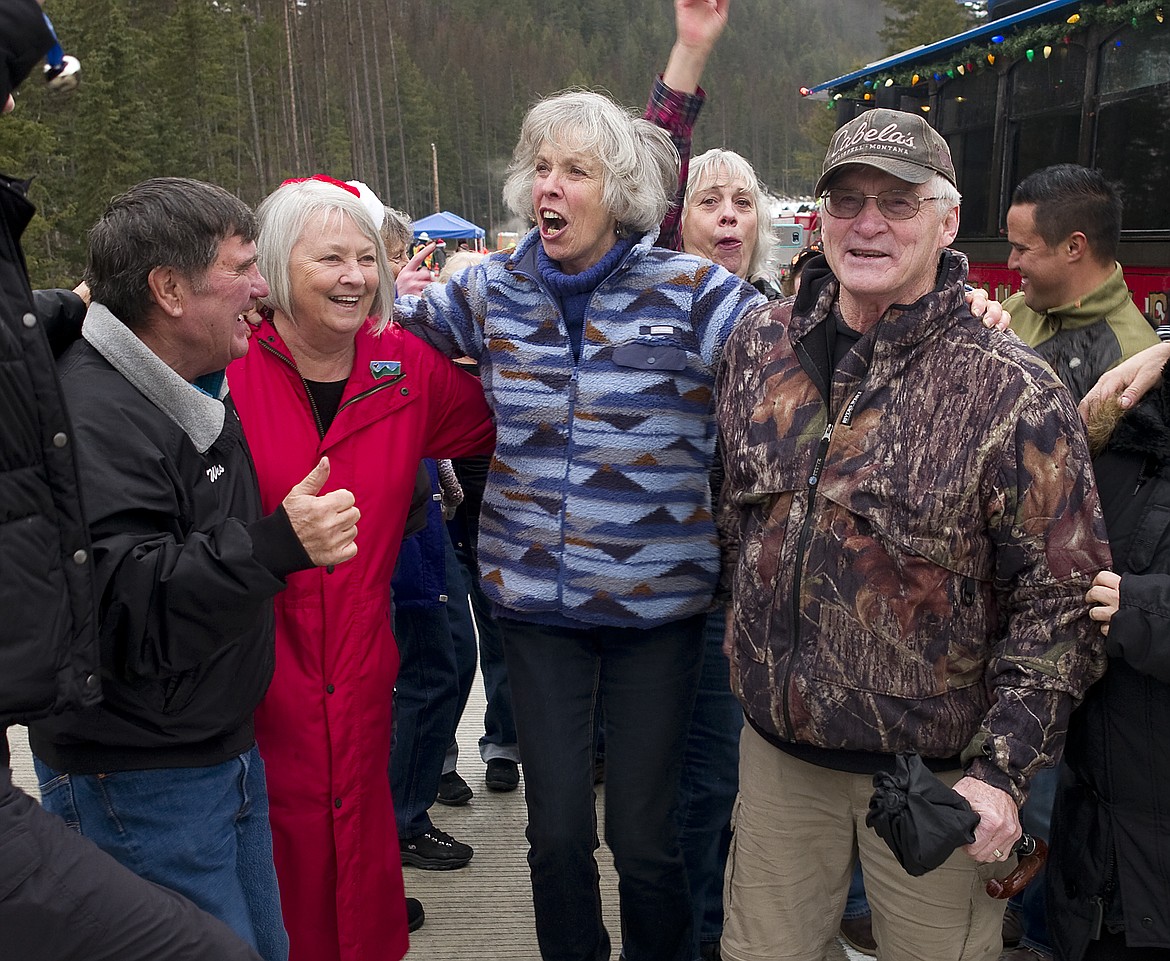 From left, Steve Brown, Montana State District 2 Sen. Dee Brown, Marion Foley and Paul Snyder do a little celebration dance on the new South Fork Bridge Monday afternoon. The $13.2 million structure is now open to traffic. Brown won the raffle drawing to cross the bridge first. The raffle, the idea of Cal Grise, raised funds to the Martin City and Hungry Horse Fire Departments.