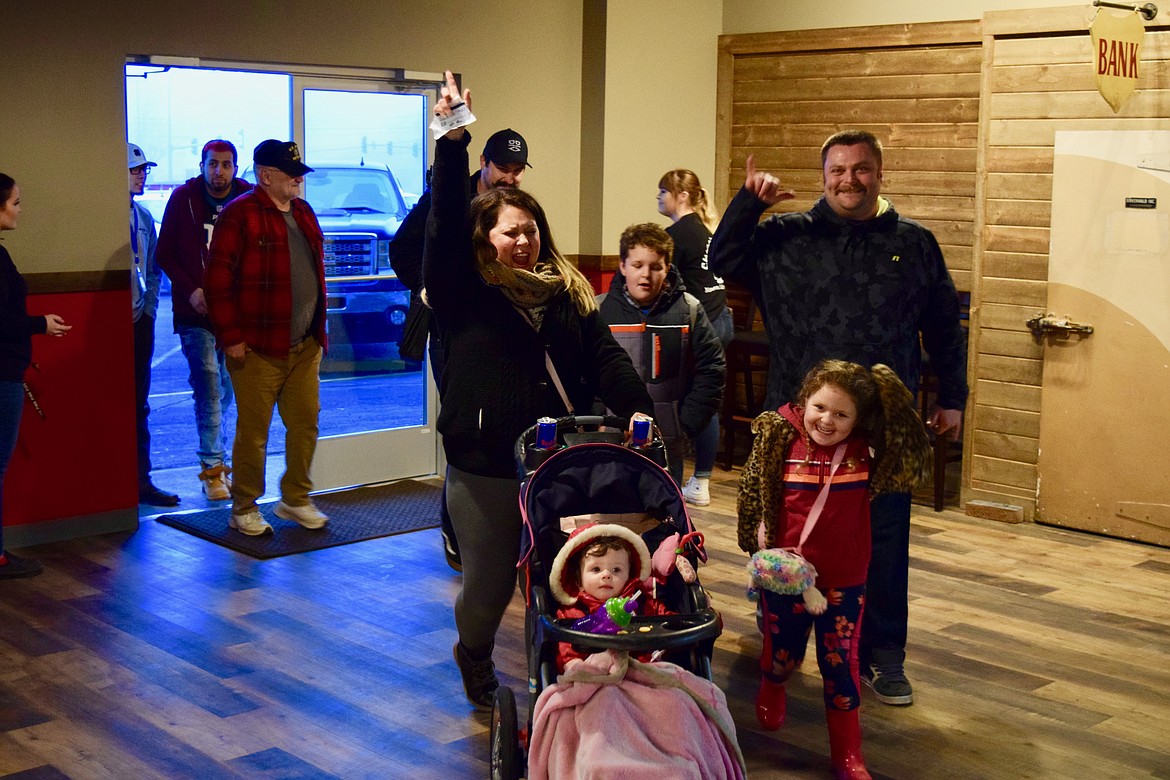 Charles H. Featherstone/Columbia Basin Herald
Happy customers walk into Chicago right after the doors open for the first time in nearly a year on Monday.