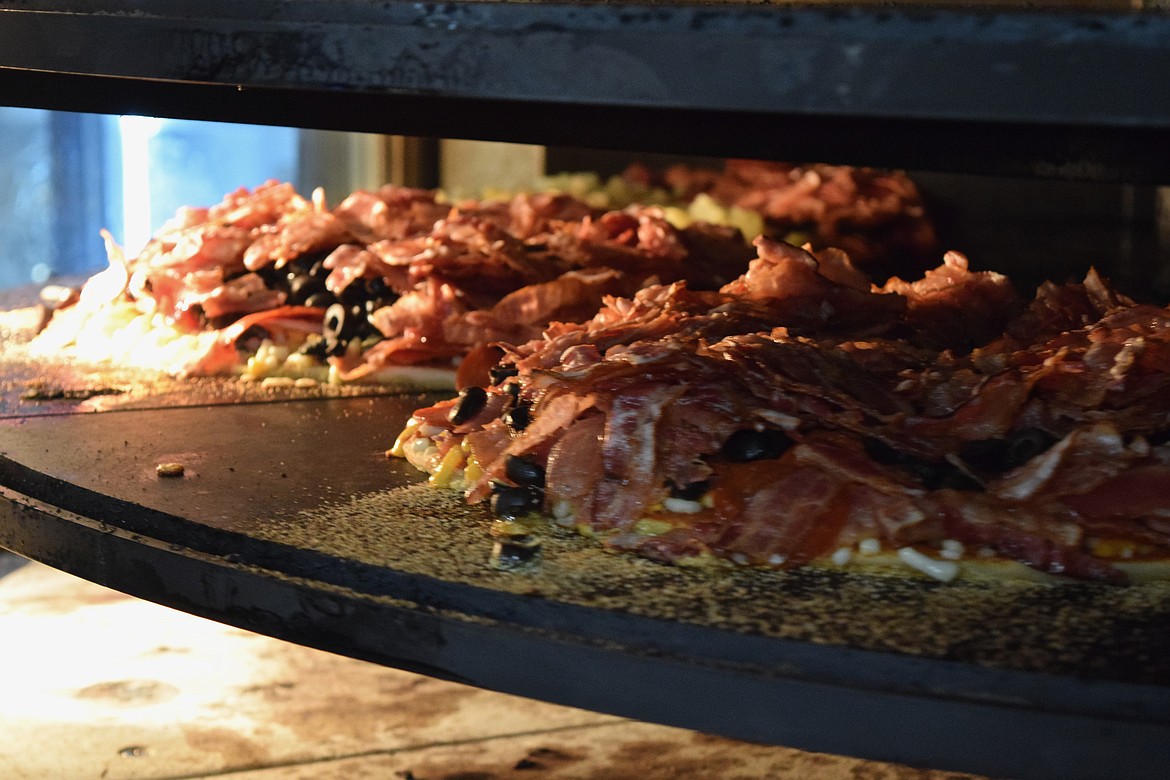 Charles H. Featherstone/Columbia Basin Herald
A pair of Hochstatter Specials bake in Chico&#146;s new pizza oven.