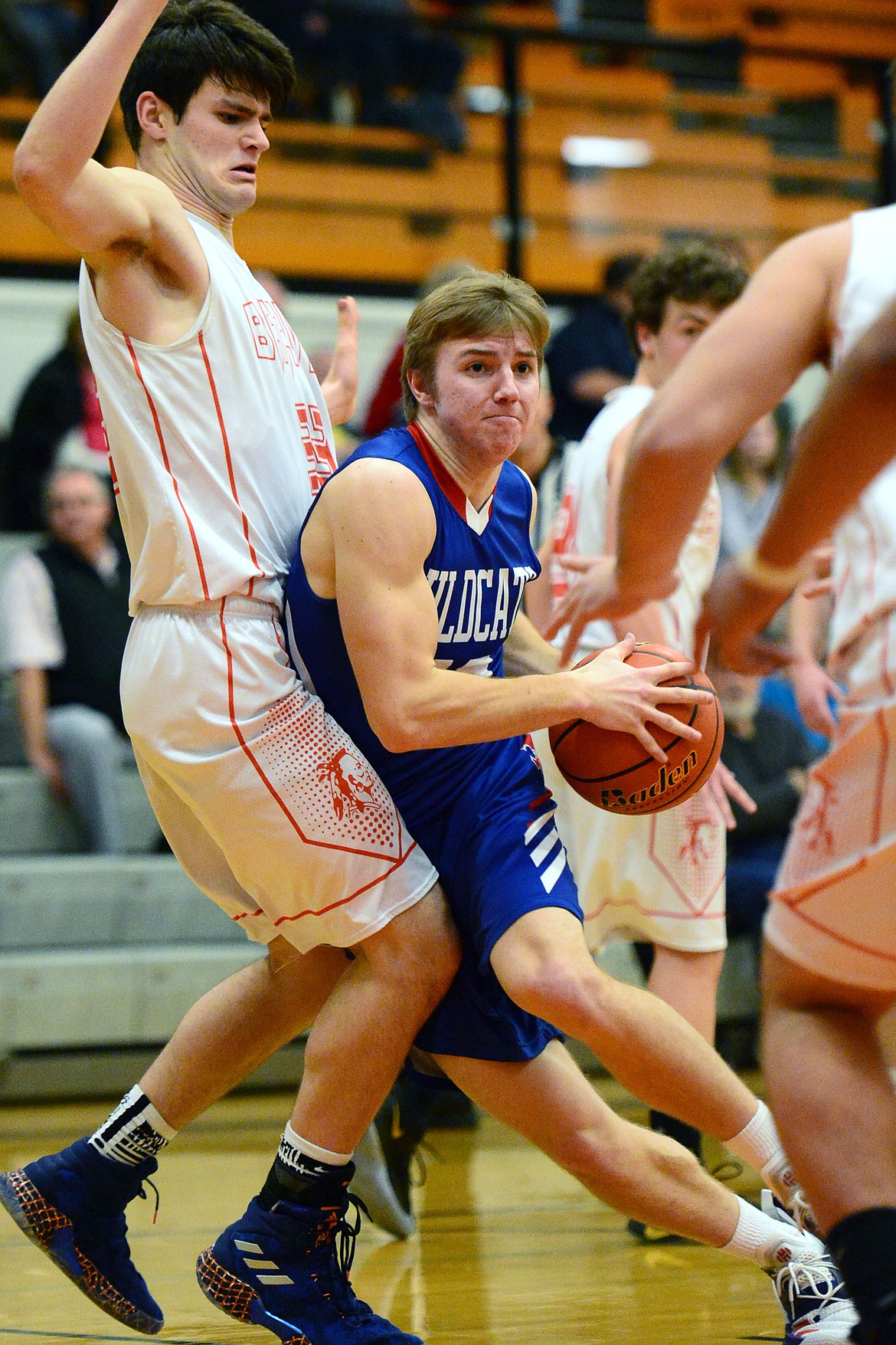 Columbia Falls' Drew Morgan (12) drives to the basket with Flathead's Gabe Adams (33) defending at Flathead High School on Saturday. (Casey Kreider/Daily Inter Lake)