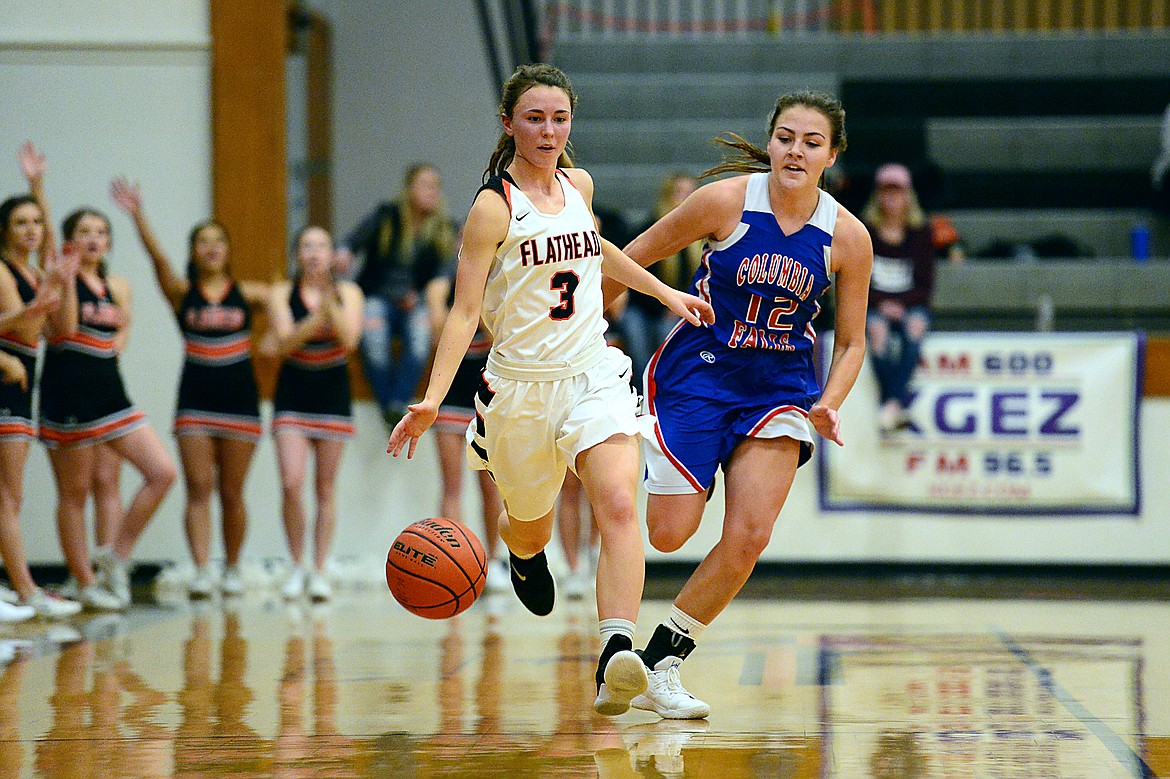 Flathead's Sadie Wilson (3) brings the ball upcourt with Columbia Falls' LaKia Smith (12) in pursuit at Flathead High School on Saturday. (Casey Kreider/Daily Inter Lake)