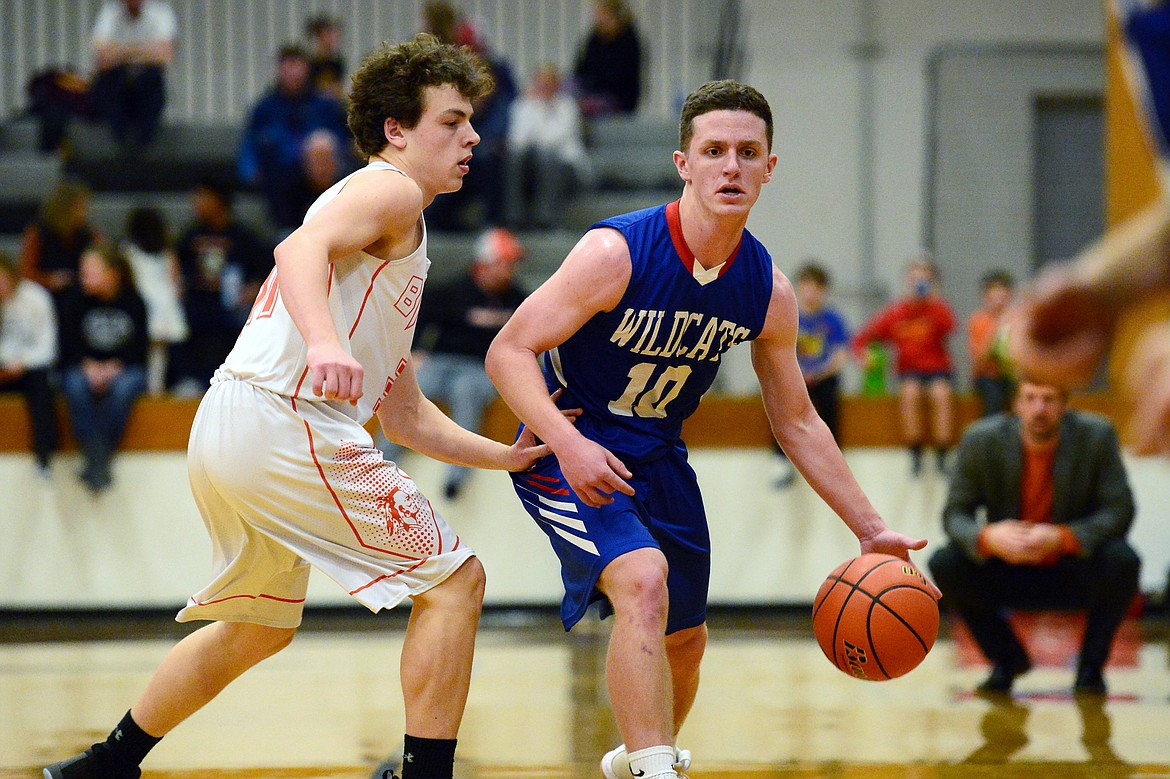 Columbia Falls' Dillon Wanner (10) brings the ball upcourt with Flathead's Brett Thompson (31) defending at Flathead High School on Saturday. (Casey Kreider/Daily Inter Lake)