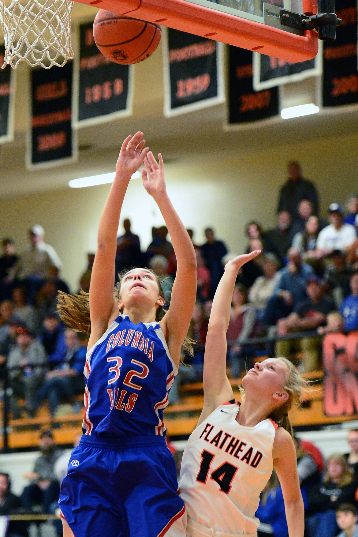 Columbia Falls' Madysen Hoerner (32) goes to the hoop over Flathead's Jenna Johnson (14) at Flathead High School on Saturday. (Casey Kreider/Daily Inter Lake)