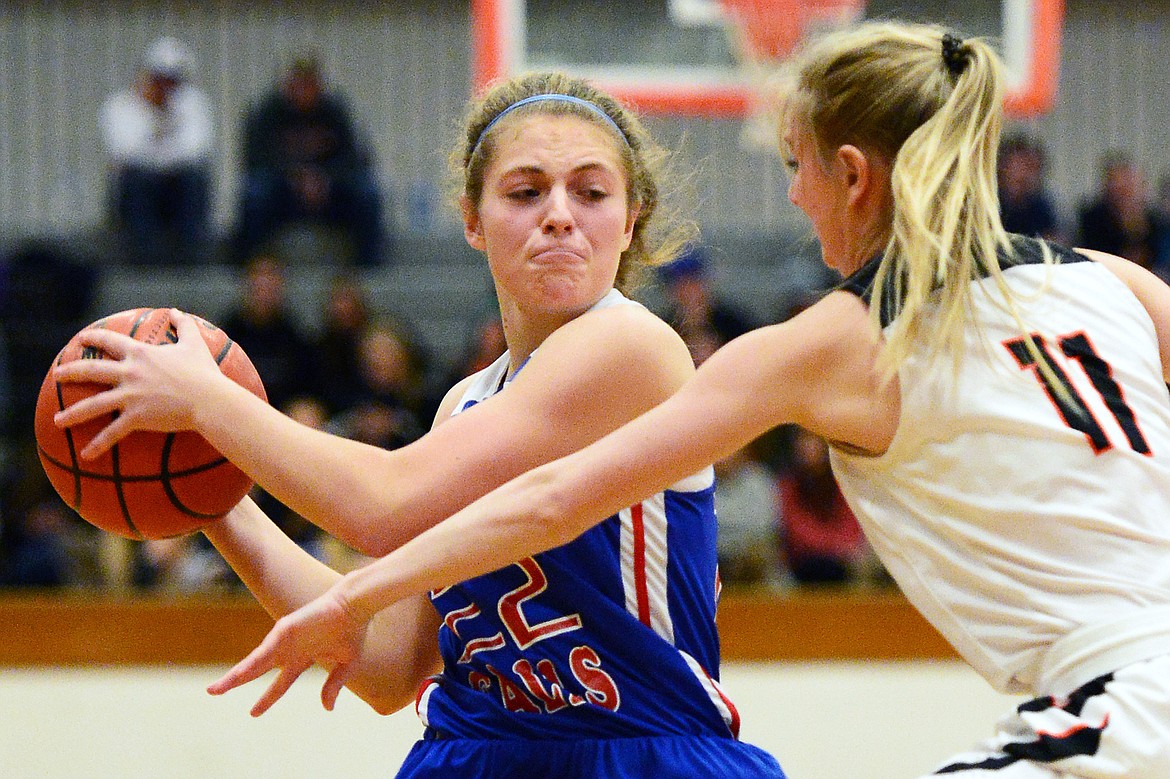 Columbia Falls' Hannah Schweikert (22) looks to pass with Flathead's Kaysie Malmin (11) defending at Flathead High School on Saturday. (Casey Kreider/Daily Inter Lake)