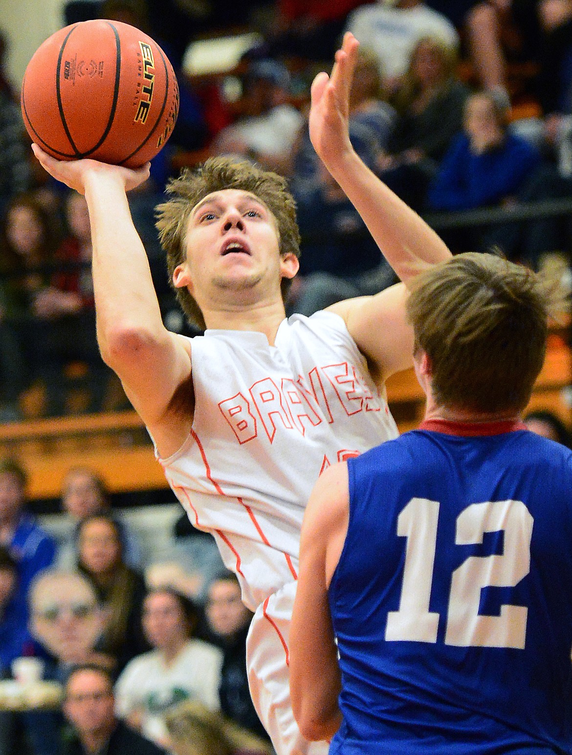 Flathead's Stephen Bridges (10) shoots over Columbia Falls' Drew Morgan (12) at Flathead High School on Saturday. (Casey Kreider/Daily Inter Lake)