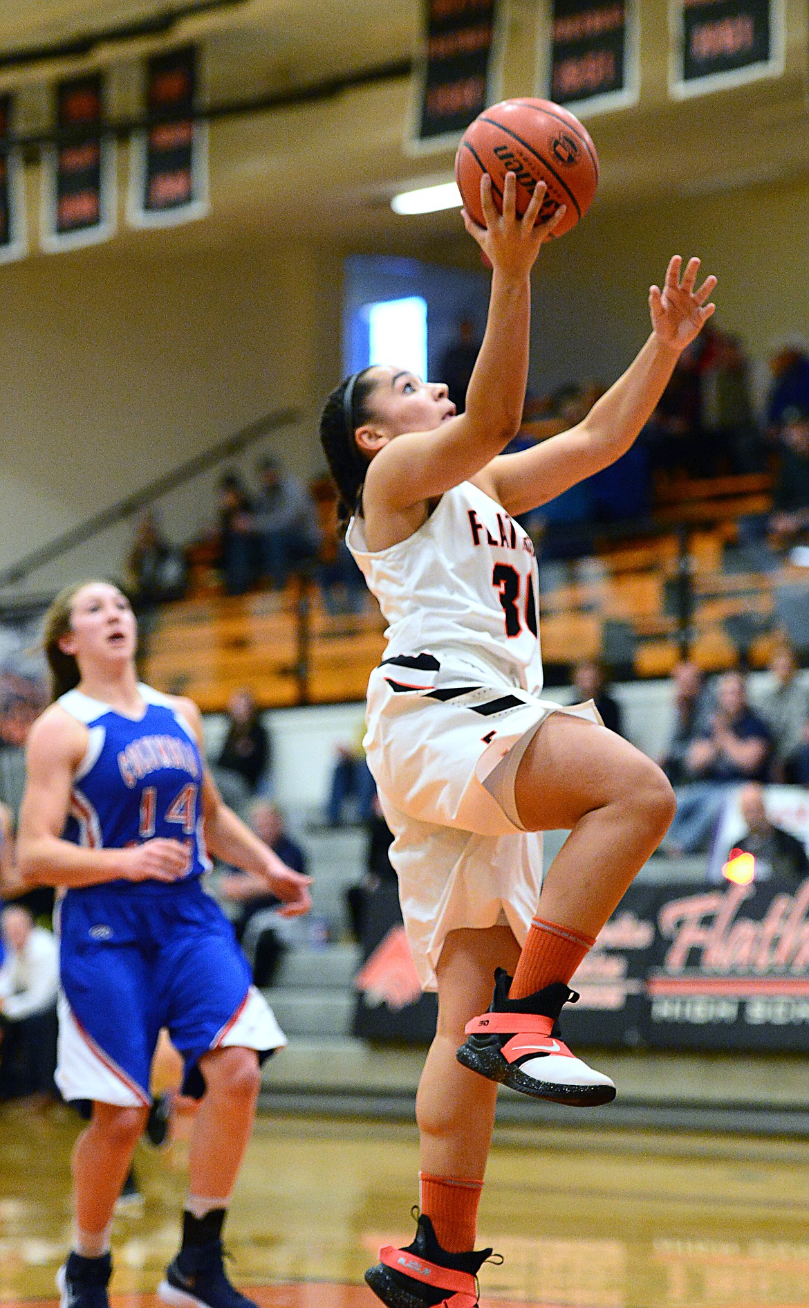 Flathead's Kayla Martin (30) drives to the basket against Columbia Falls at Flathead High School on Saturday. (Casey Kreider/Daily Inter Lake)