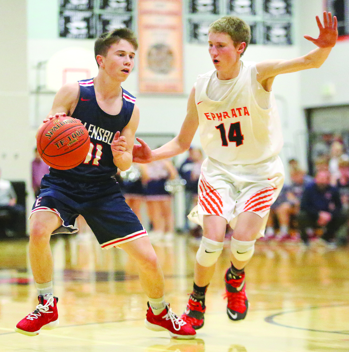 Connor Vanderweyst/Columbia Basin Herald
Ephrata's Lakota Lange (14) guards Ellensburg point guard Davis Grant.