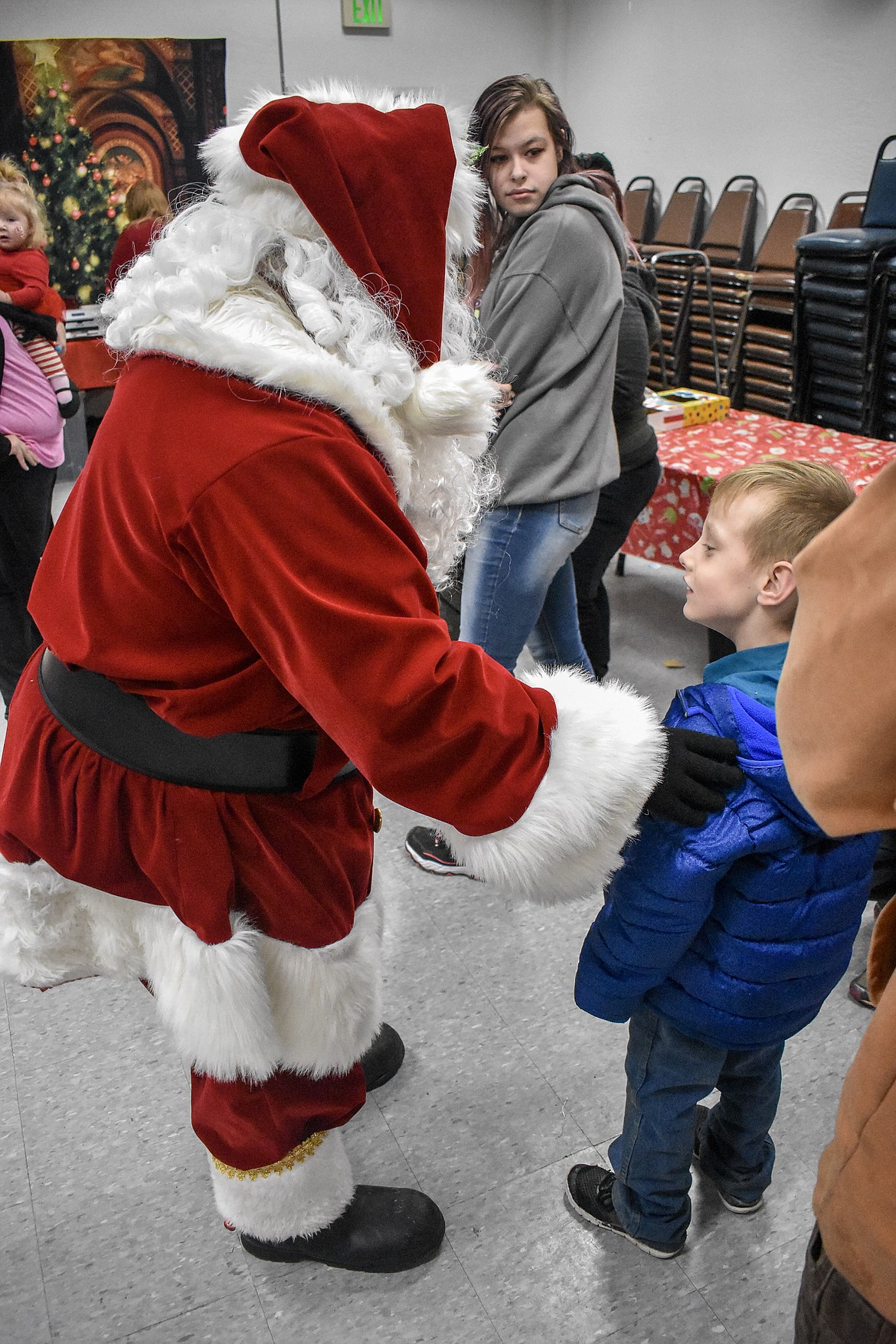 Six year old Aden Daniell visits with Santa Claus at Libby VFW Post 1548 Sunday during the Lincoln County Christmas Annual Toy Giveaway. (Ben Kibbey/The Western News)