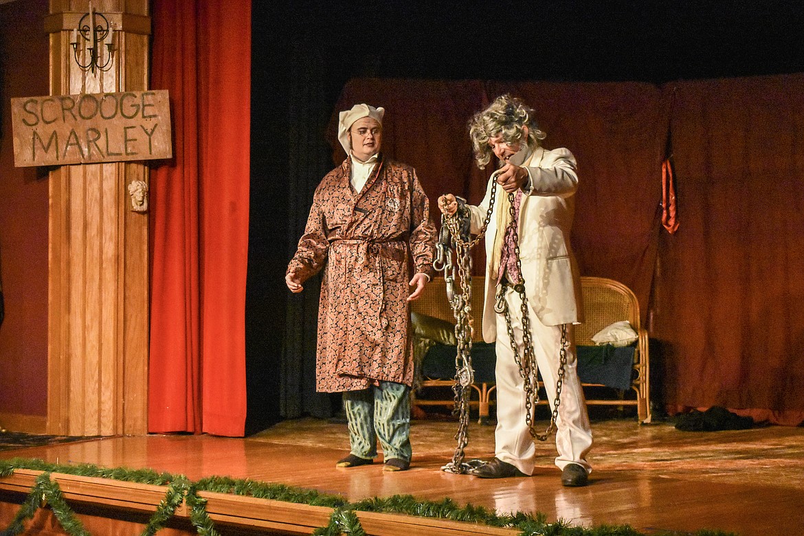 Scrooge, played by Raymond Miller, converses with his former partner Marley, played by Keith Meyers, during the Pitiful Players production of A Christmas Carol at the K.W. Maki Theater Sunday. (Ben Kibbey/The Western News)