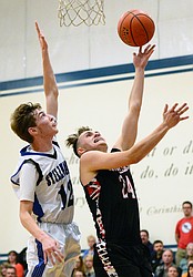 Flathead Valley Homeschool's Spencer Burden (24) drives to the hoop with Stillwater Christian's Nicholas Sulzbacher (12) defending at Stillwater Christian School on Friday. (Casey Kreider/Daily Inter Lake)