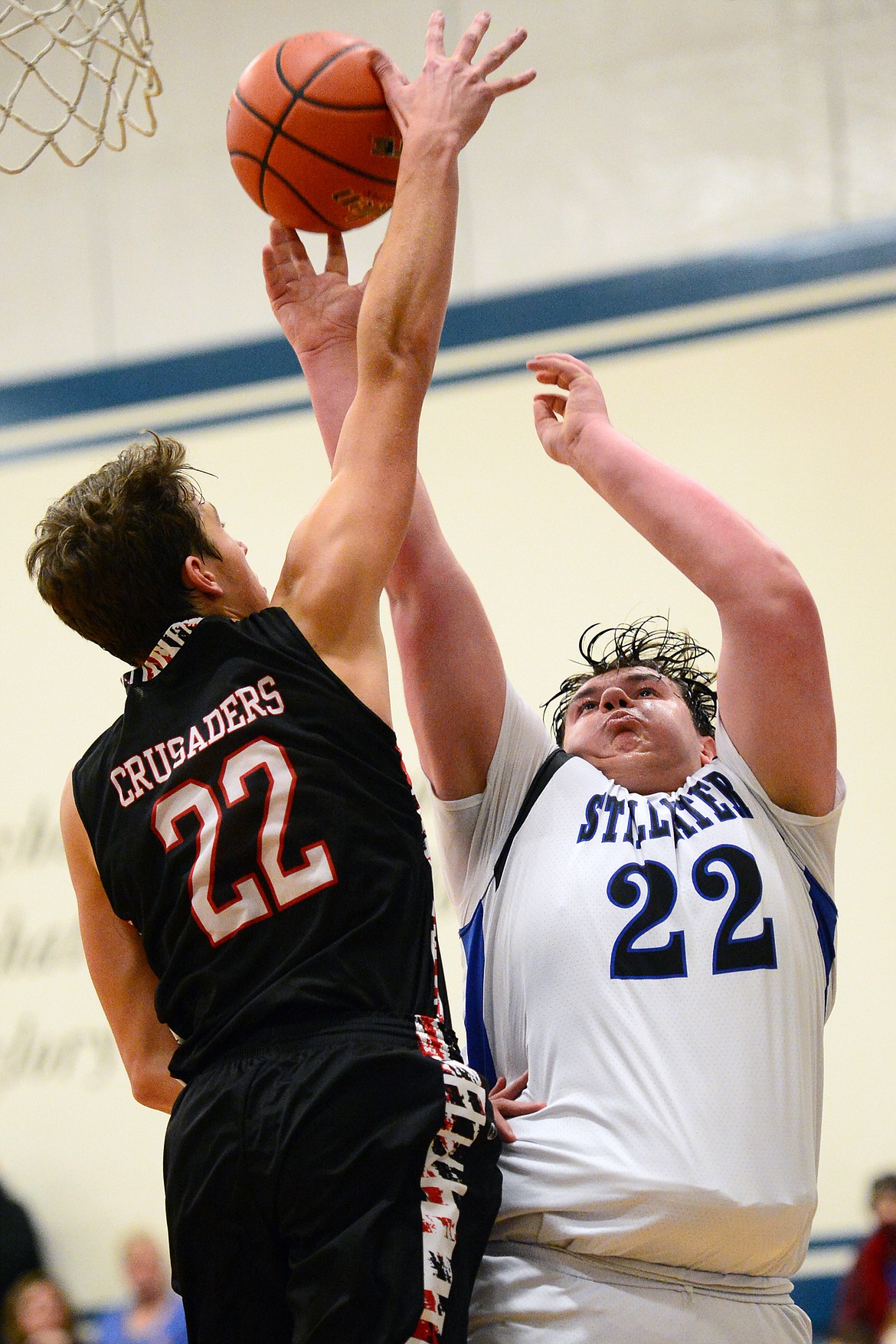 Flathead Valley Homeschool's Bubba Loyda (22) blocks the shot of Stillwater Christian's Jeremiah Hooker (22) at Stillwater Christian School on Friday. (Casey Kreider/Daily Inter Lake)