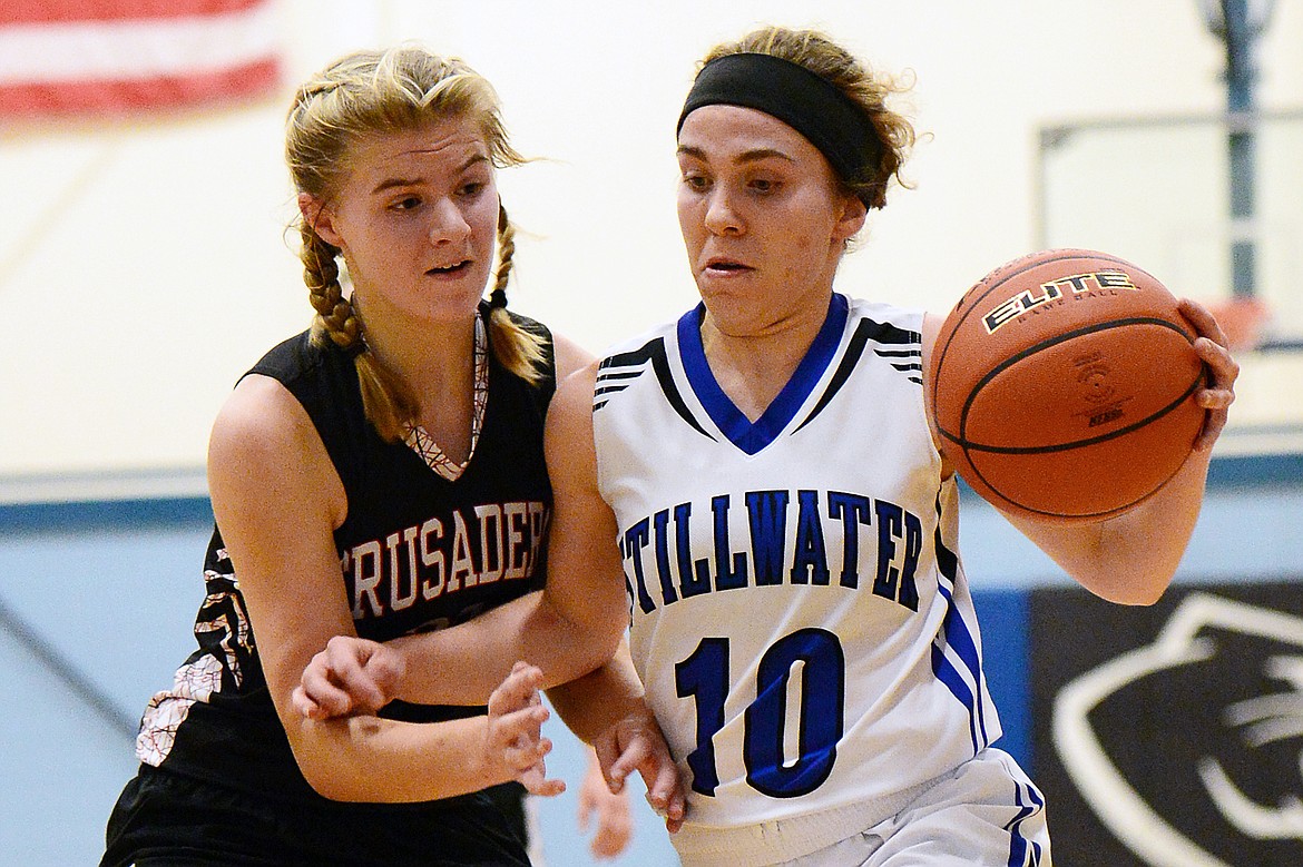 Stillwater Christian's Cora Boll (10) brings the ball upcourt with Flathead Valley Homeschool's Corey Connerly (22) defending at Stillwater Christian School on Friday. (Casey Kreider/Daily Inter Lake)