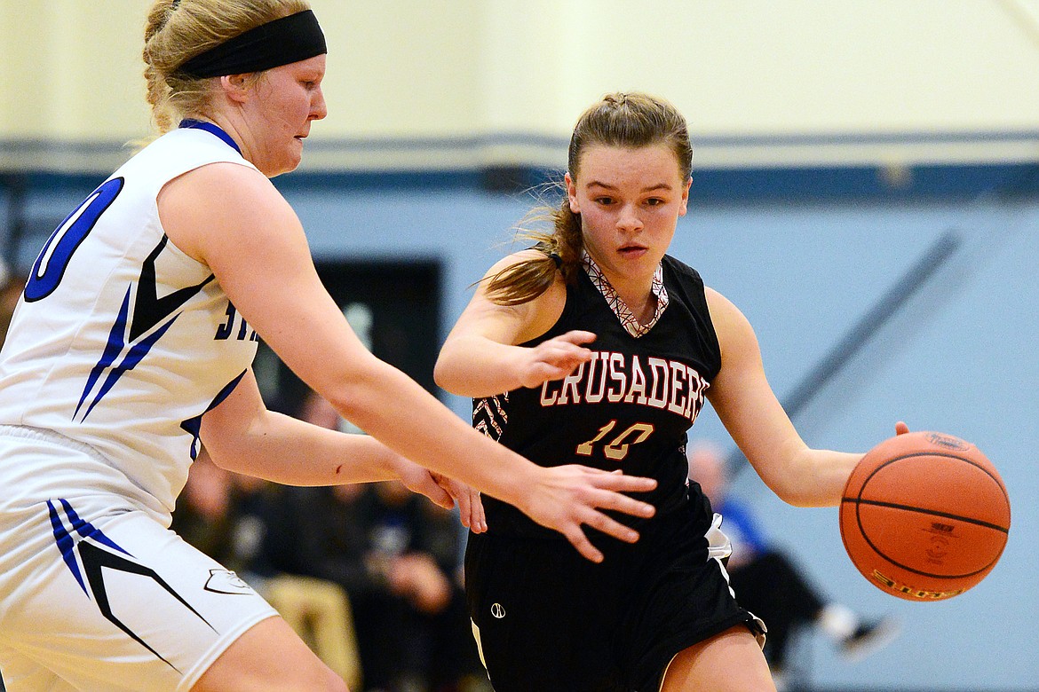 Flathead Valley Homeschool's Codi Kenney (10) drives to the hoop with Stillwater Christian's Selah Neumann (40) defending at Stillwater Christian School on Friday. (Casey Kreider/Daily Inter Lake)