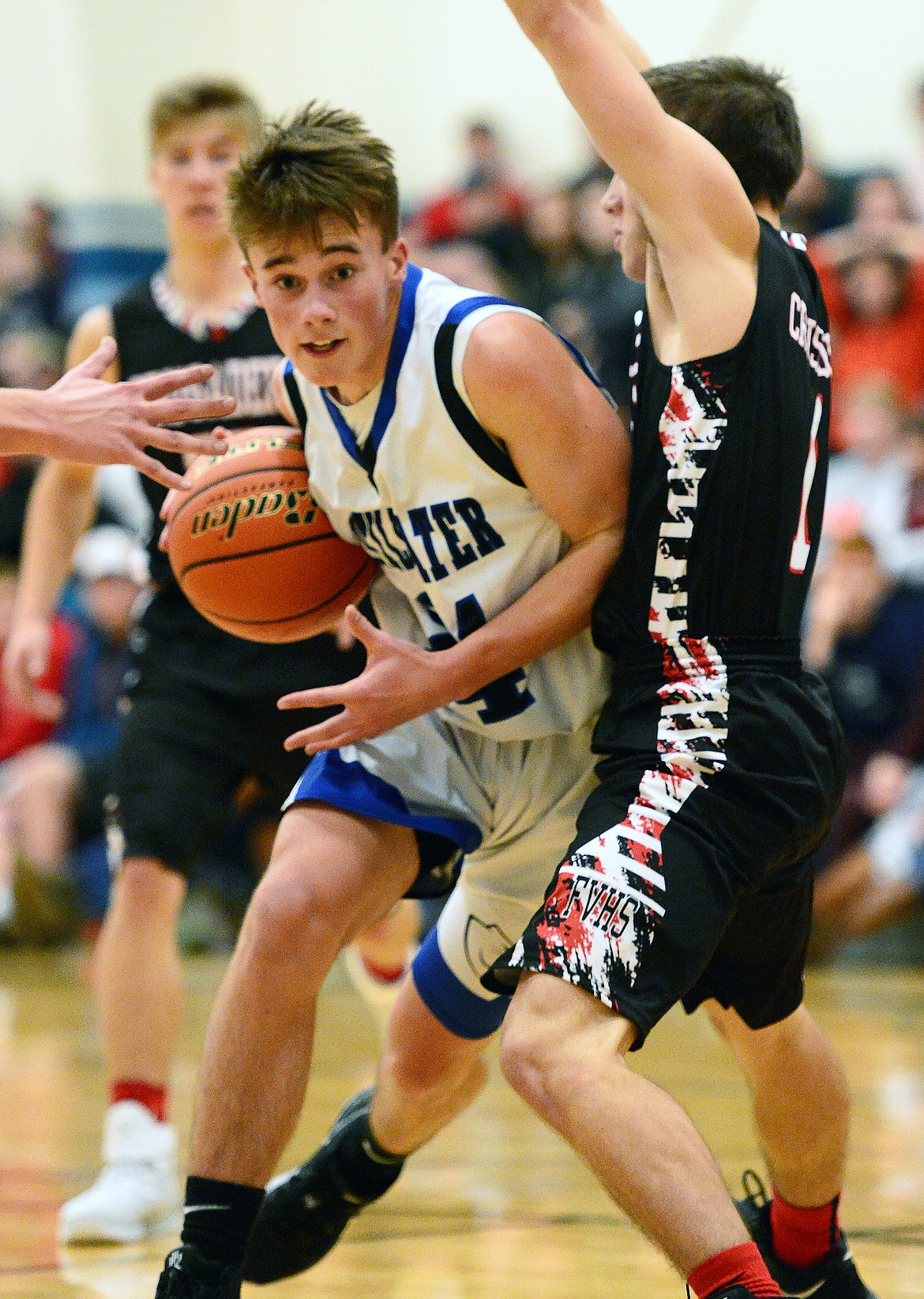 Stillwater Christian's Caleb Cole-Tinkham (24) drives to the hoop with Flathead Valley Homeschool's Hans Artyomenko (1) defending at Stillwater Christian School on Friday. (Casey Kreider/Daily Inter Lake)