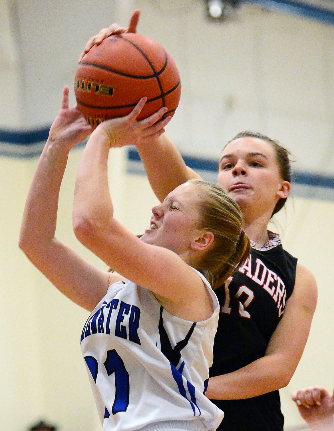 Stillwater Christian's Marae Tintzman (21) has her shot blocked by Flathead Valley Homeschool's Codi Kenney (10) at Stillwater Christian School on Friday. (Casey Kreider/Daily Inter Lake)