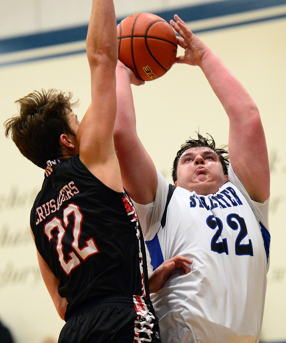 Stillwater Christian's Jeremiah Hooker (22) drives to the hoop with Flathead Valley Homeschool's Bubba Loyda (22) defending at Stillwater Christian School on Friday. (Casey Kreider/Daily Inter Lake)