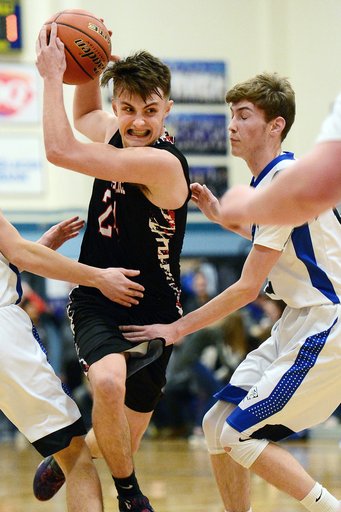 Flathead Valley Homeschool's Spencer Burden (24) drives the lane with Stillwater Christian's Nicholas Sulzbacher (12) defending at Stillwater Christian School on Friday. (Casey Kreider/Daily Inter Lake)