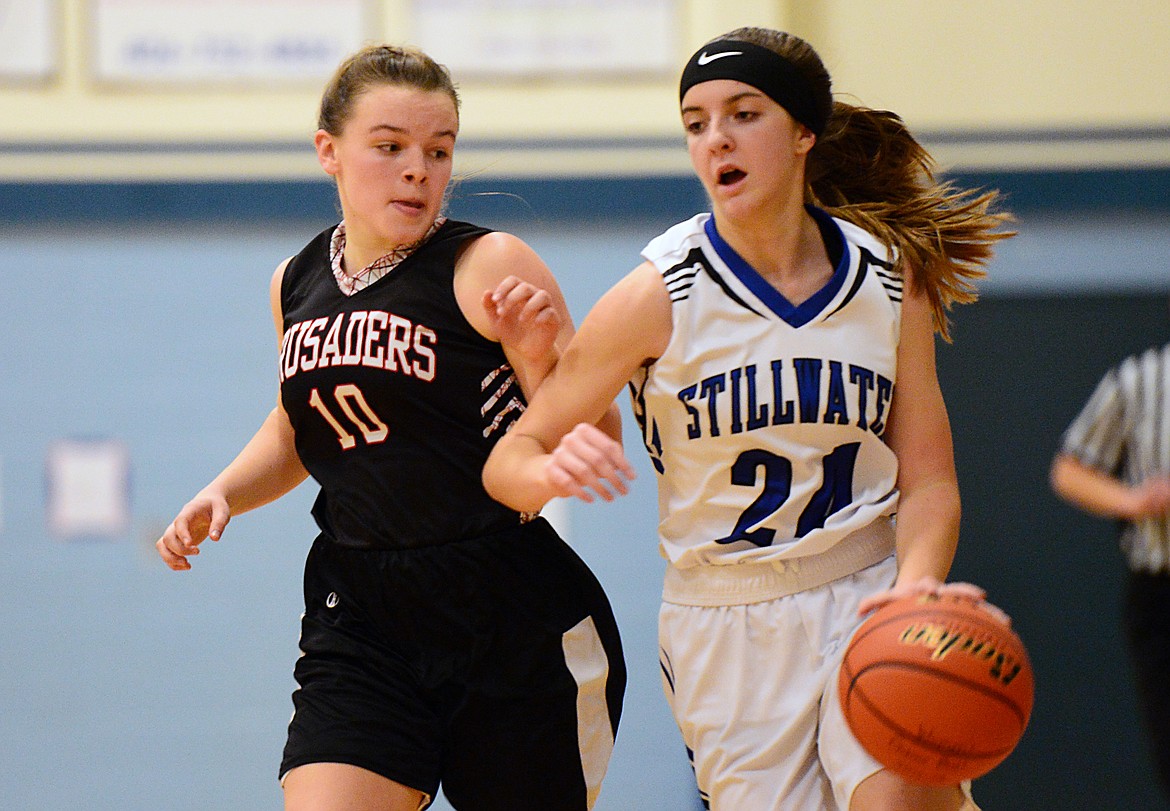 Stillwater Christian's Madison Morken (24) brings the ball upcourt with Flathead Valley Homeschool's Codi Kenney (10) defending at Stillwater Christian School on Friday. (Casey Kreider/Daily Inter Lake)