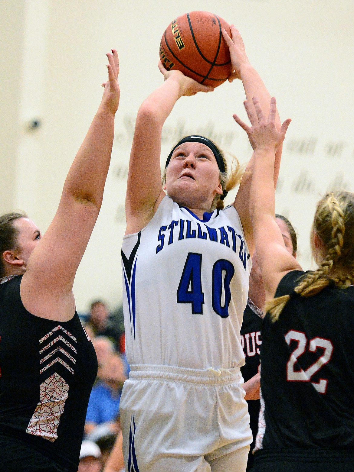 Stillwater Christian's Selah Neumann (40) shoots between Flathead Valley Homeschool defenders Britney Howery (13) and Corey Connerly (22) at Stillwater Christian School on Friday. (Casey Kreider/Daily Inter Lake)