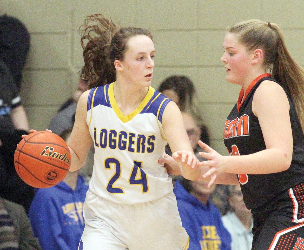 Senior Jayden Winslow looks for the lane in the fourth quarter while being guarded by Ronan&#146;s Jaylea Lunceford Saturday at Ralph Tate Gymnasium. (Paul Sievers/The Western News)