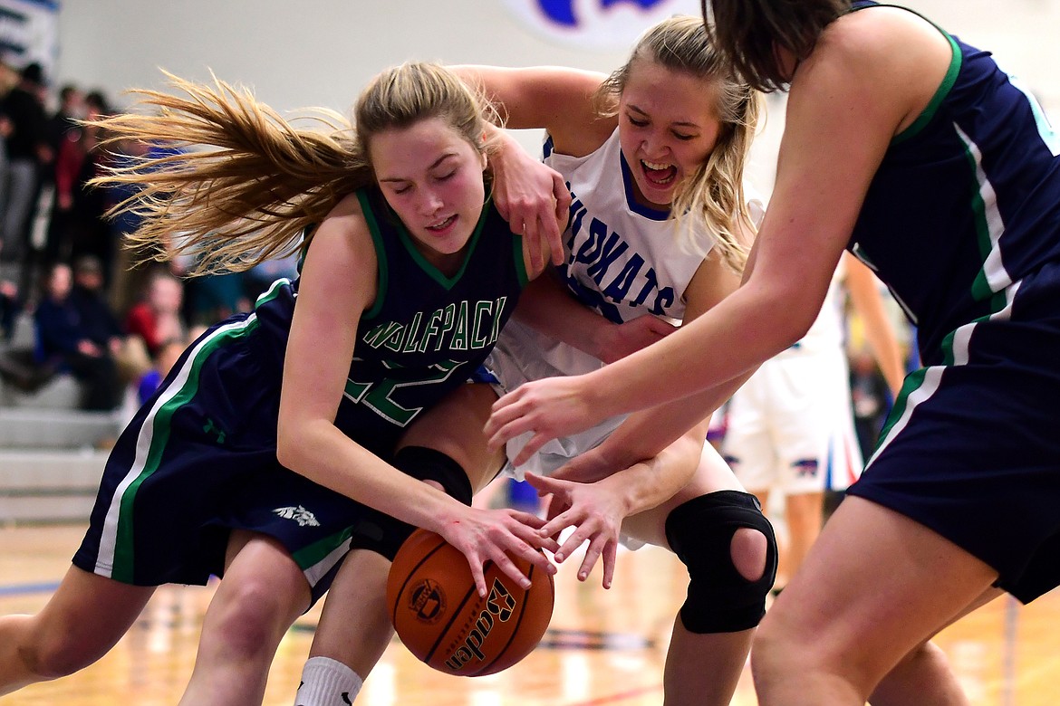 Ryley Kehr battles Glacier&#146;s Ellie Keller for a loose ball during the first quarter Thursday. Kehr finished with 15 points as the Wildkats defeated the Lady Wolfpack 37-10. (Jeremy Weber photo)