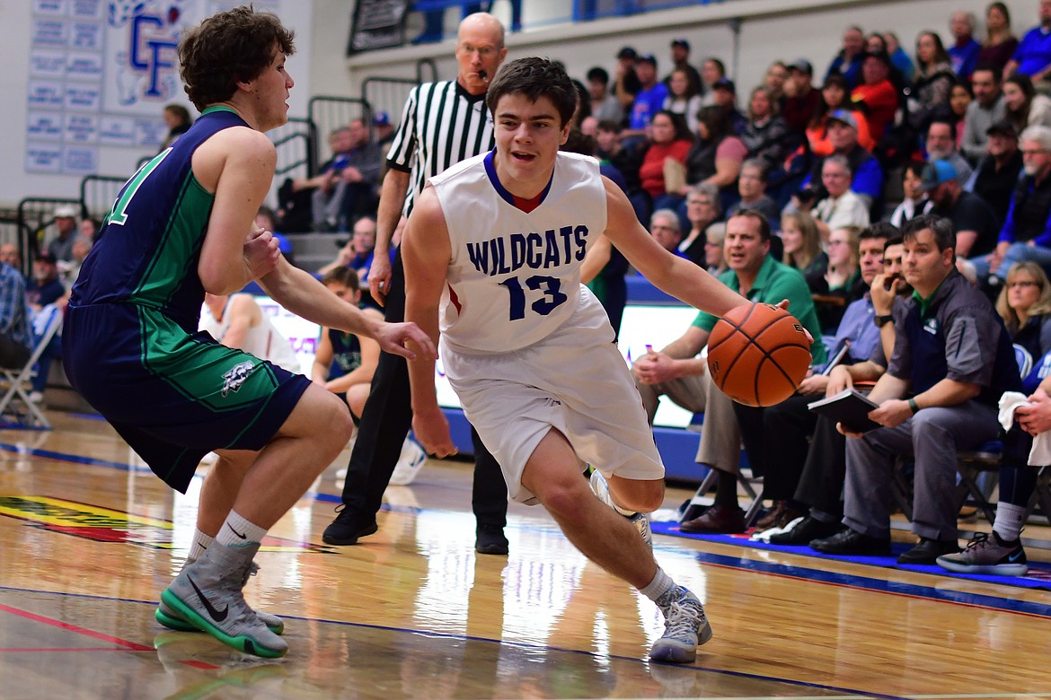 Dillon Shipp drives past Glacier&#146;s Kyle Buckingham in the first quarter Thurday. Shipp finished with 14 points in the contest. (Jeremy Weber photo)