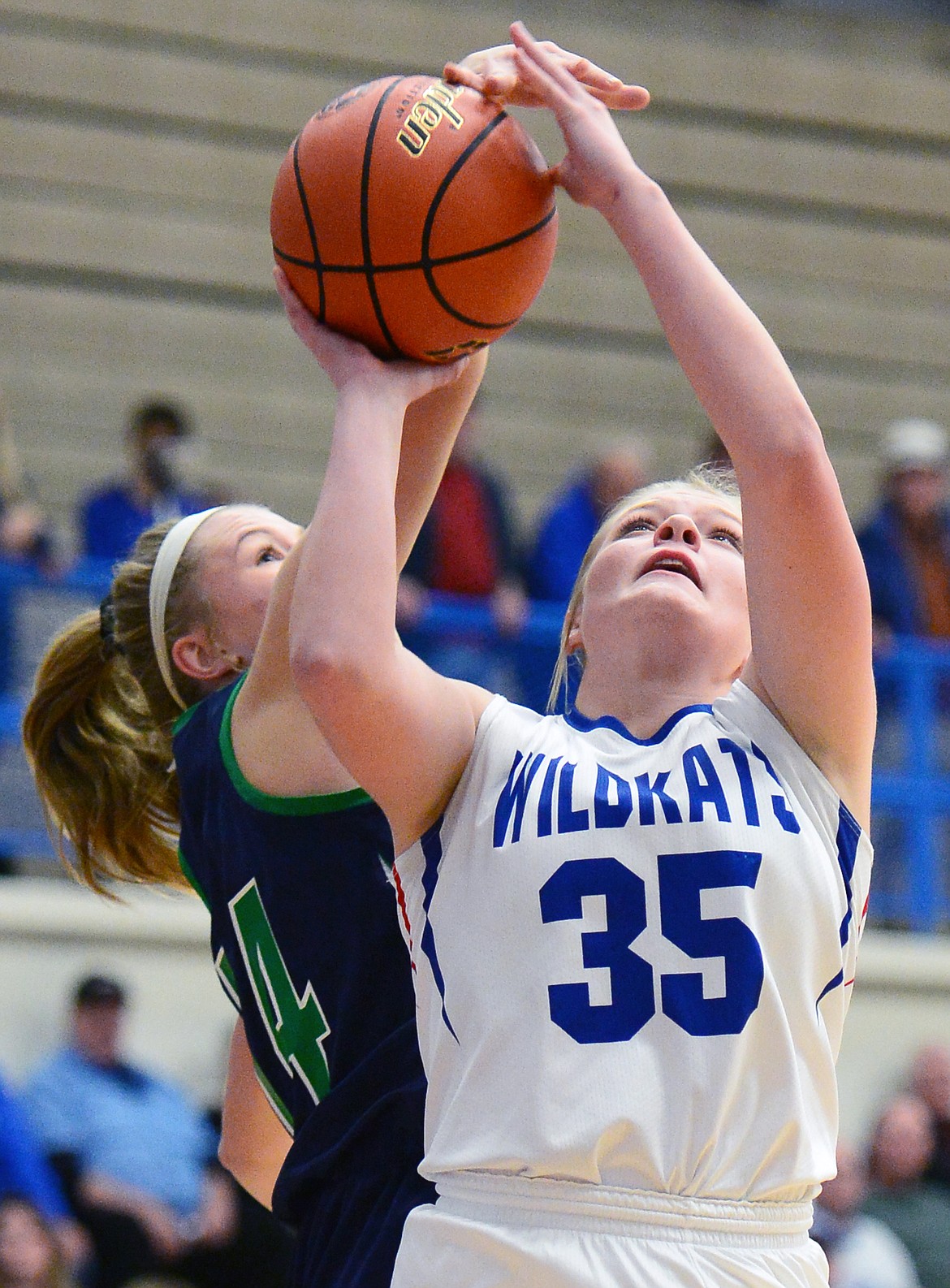 Glacier's Aubrie Rademacher (14) blocks a shot by Columbia Falls' Trista Cowen (35) at Columbia Falls High School on Thursday. (Casey Kreider/Daily Inter Lake)