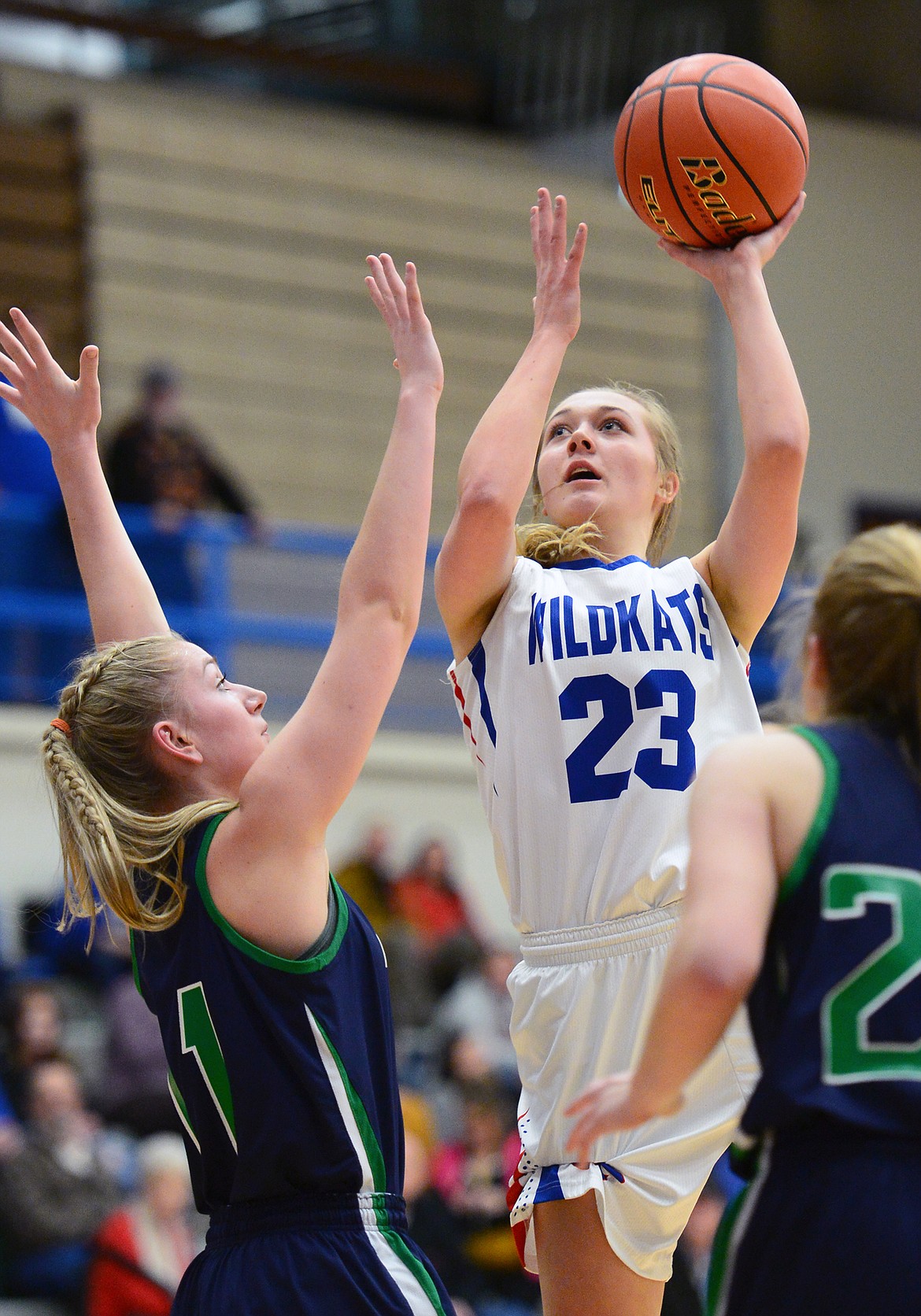 Columbia Falls' Ryley Kehr (23) shoots over Glacier defenders Kaileigh Crawford (11) and Ellie Keller (22) at Columbia Falls High School on Thursday. (Casey Kreider/Daily Inter Lake)