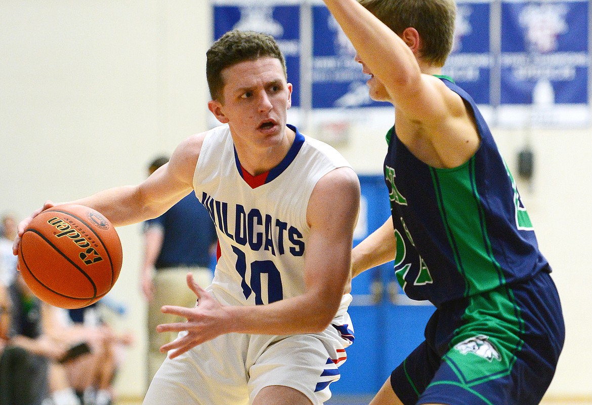 Columbia Falls' Dillon Wanner (10) looks to dribble around the defense of Glacier's Michael Schwarz (22) at Columbia Falls High School on Thursday. (Casey Kreider/Daily Inter Lake)