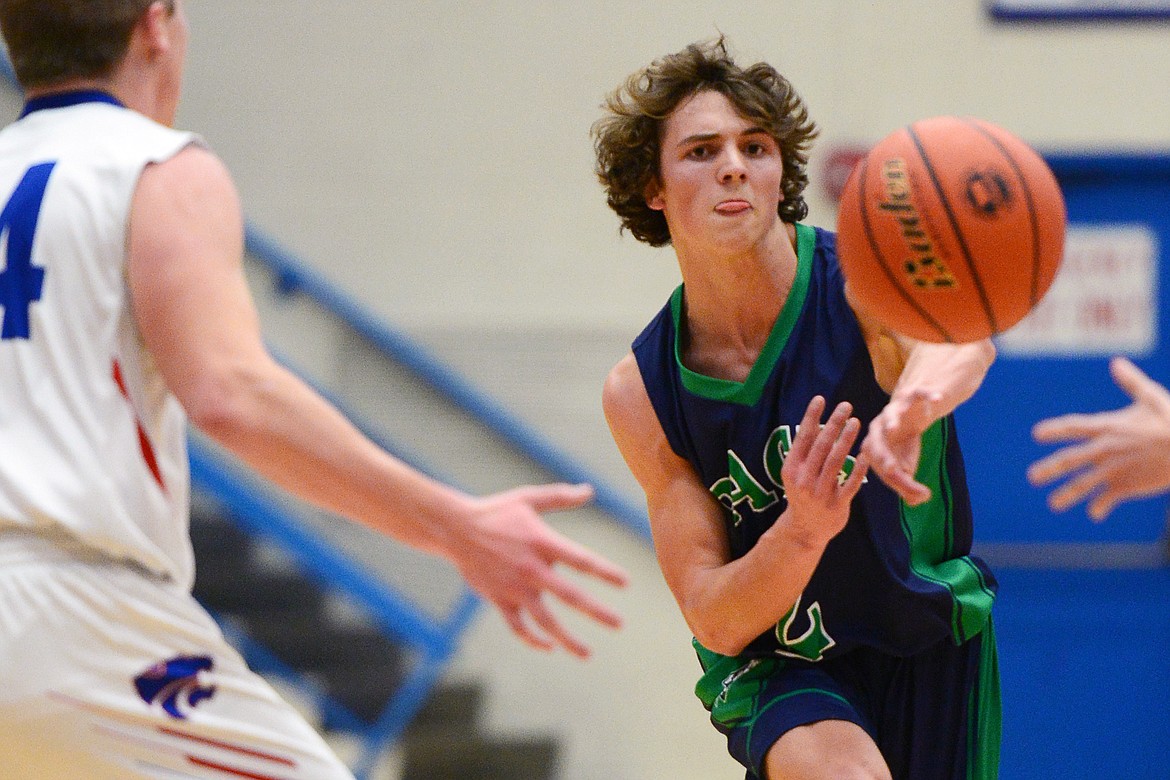 Glacier's Drew Deck (2) fires a pass under the basket in the first half against Columbia Falls at Columbia Falls High School on Thursday. (Casey Kreider/Daily Inter Lake)