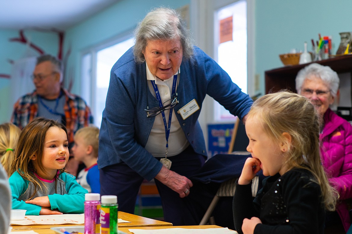 Skyluna Radatti and Gwen Hughes get ready to build ornaments with Marcia Chambers at the Children's House Montessori School last week. (Daniel McKay/Whitefish Pilot)