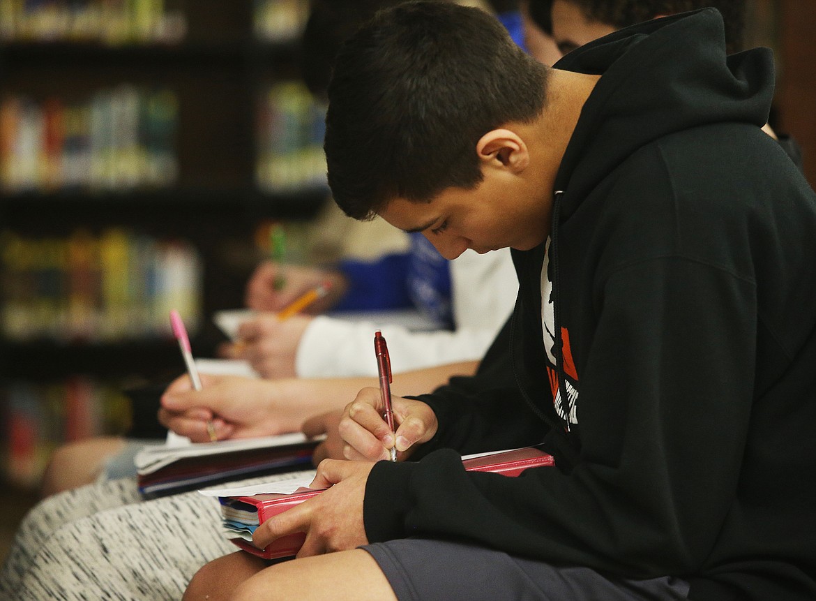 LOREN BENOIT/Press
Eighth-grader Jose Laguna fills out a worksheet as he listens to Idaho Department of Lands&#146; Kjell Truesdell speak about fire safety Monday afternoon at Post Falls Middle School.