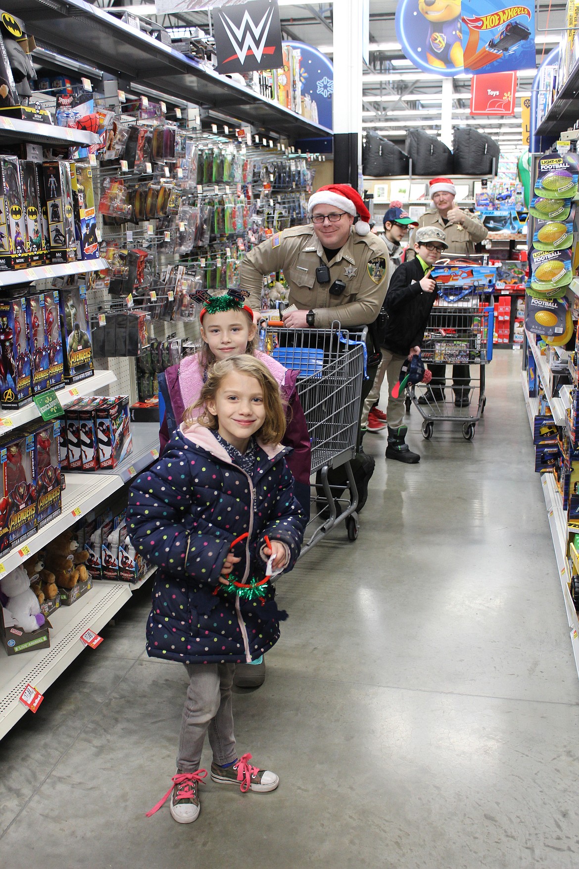 Officers and deputies with local agencies guide their assigned kids through Walmart in Smelterville to shop.
Photo by
CHANSE WATSON