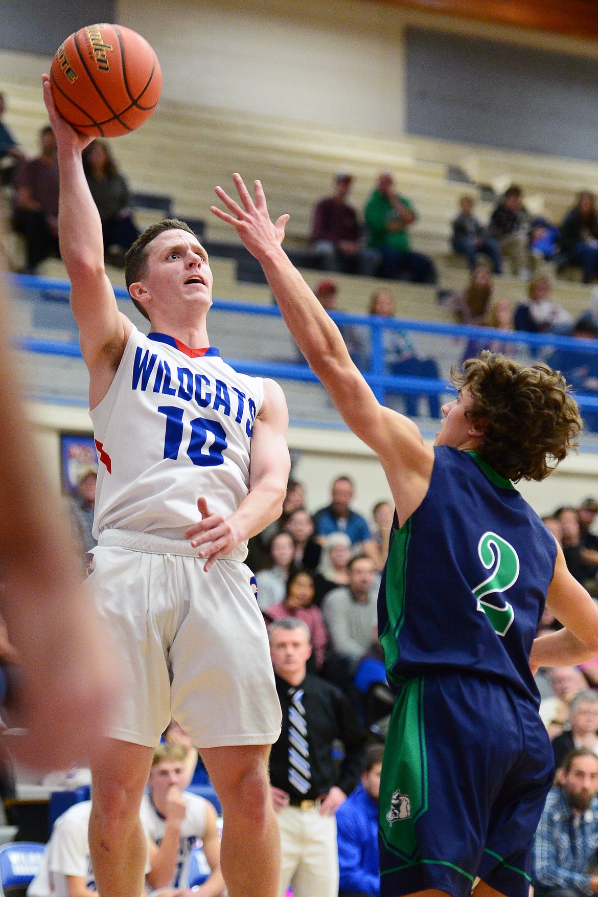 Columbia Falls' Dillon Wanner (10) shoots over Glacier's Drew Deck (2) at Columbia Falls High School on Thursday. (Casey Kreider/Daily Inter Lake)