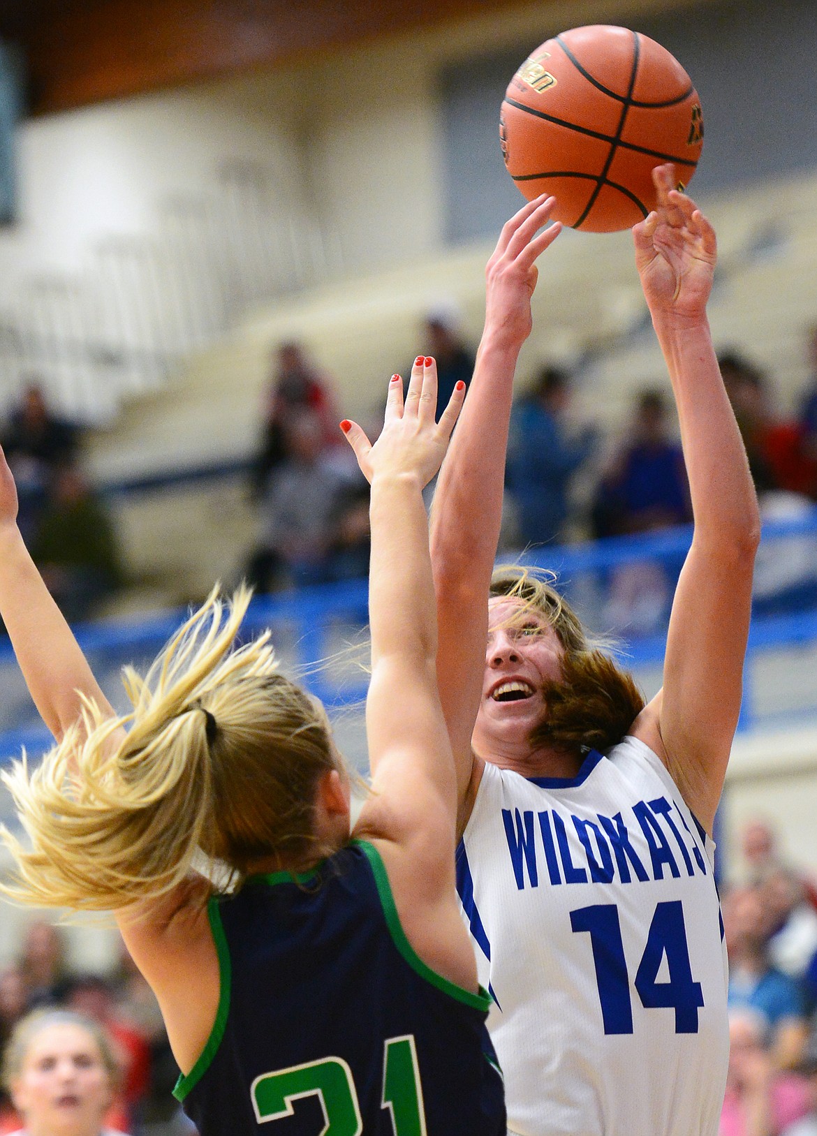 Columbia Falls' Josie Windauer (14) drives to the basket with Glacier's Abi Manger (21) defending at Columbia Falls High School on Thursday. (Casey Kreider/Daily Inter Lake)