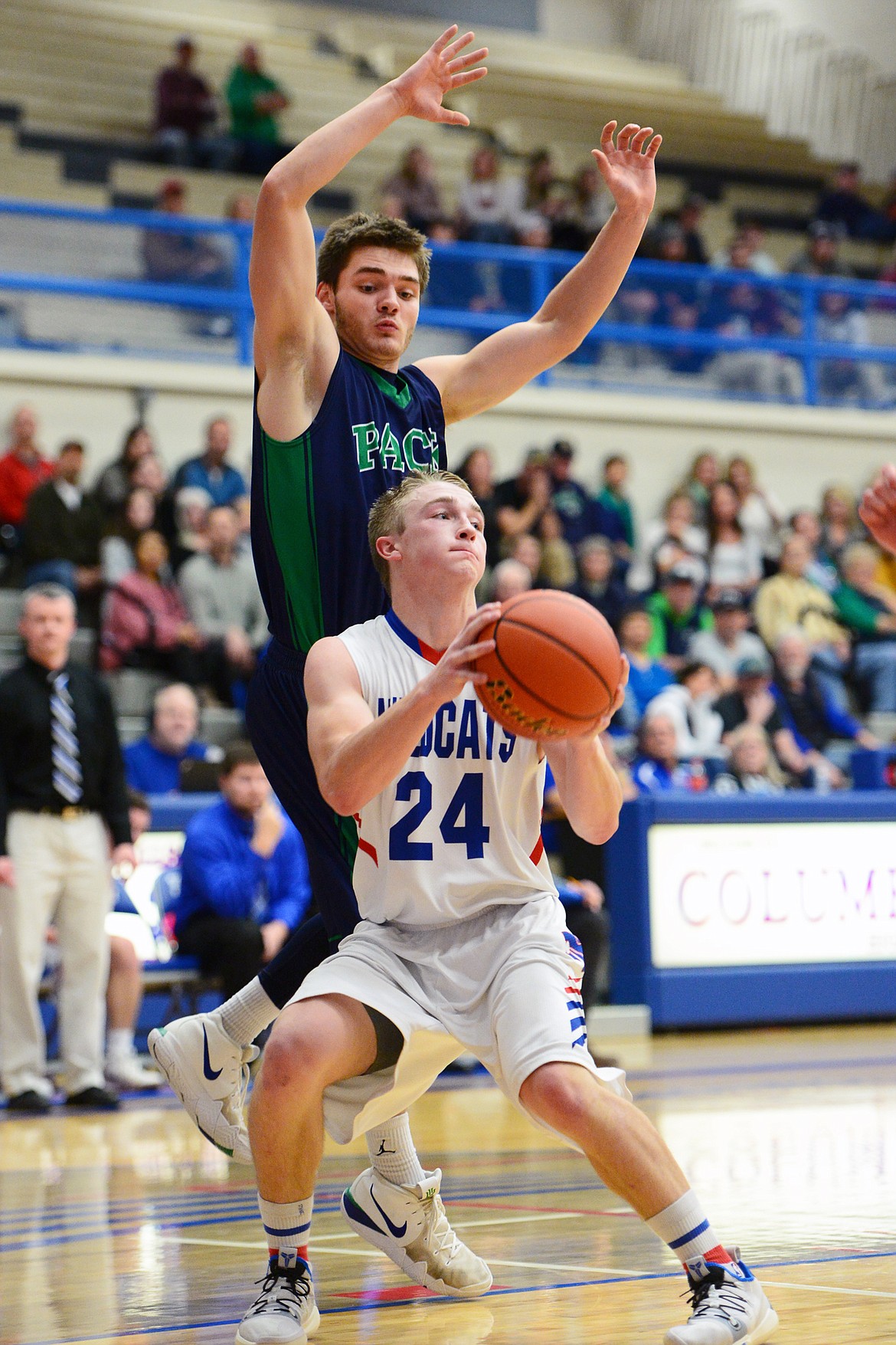 Columbia Falls' Logan Bechtel (24) drives to the hoop past Glacier's K.J. Johnson at Columbia Falls High School on Thursday. (Casey Kreider/Daily Inter Lake)