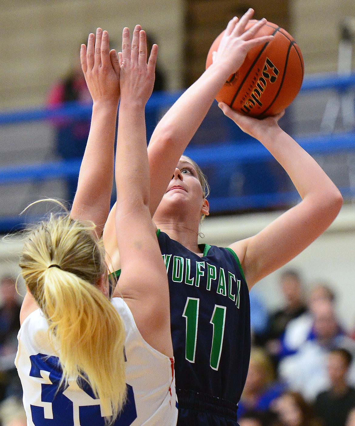 Glacier's Kaileigh Crawford (11) shoots over Columbia Falls' Trista Cowen (35) at Columbia Falls High School on Thursday. (Casey Kreider/Daily Inter Lake)