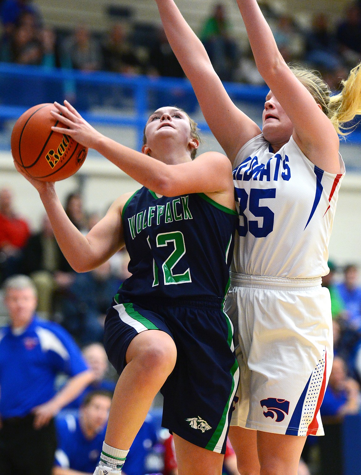 Glacier's Kenzie Williams (12) drives to the hoop past Columbia Falls' Trista Cowen (35) at Columbia Falls High School on Thursday. (Casey Kreider/Daily Inter Lake)