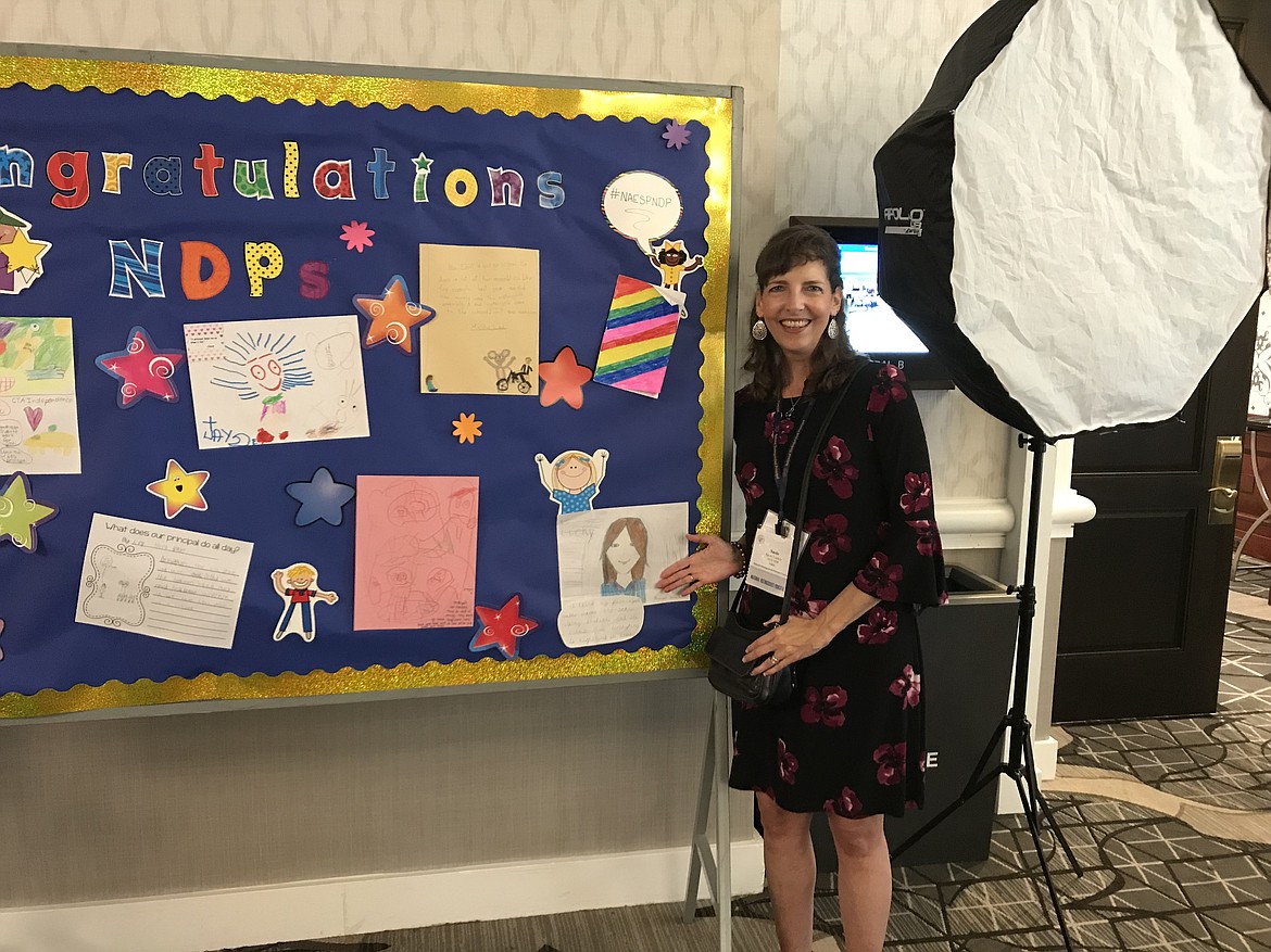 (Courtesy photo)
Idaho Hill Elementary Principal Susie Luckey was honored as Idaho&#146;s National Distinguished Principal during an event in Washington, D.C. in October. Prior to the event, principals were instructed to ask their students what they thought principals did and then send in the materials. One student drew a portrait of Luckey, which Luckey is pictured by as it was displayed in the hotel in Washington, D.C.