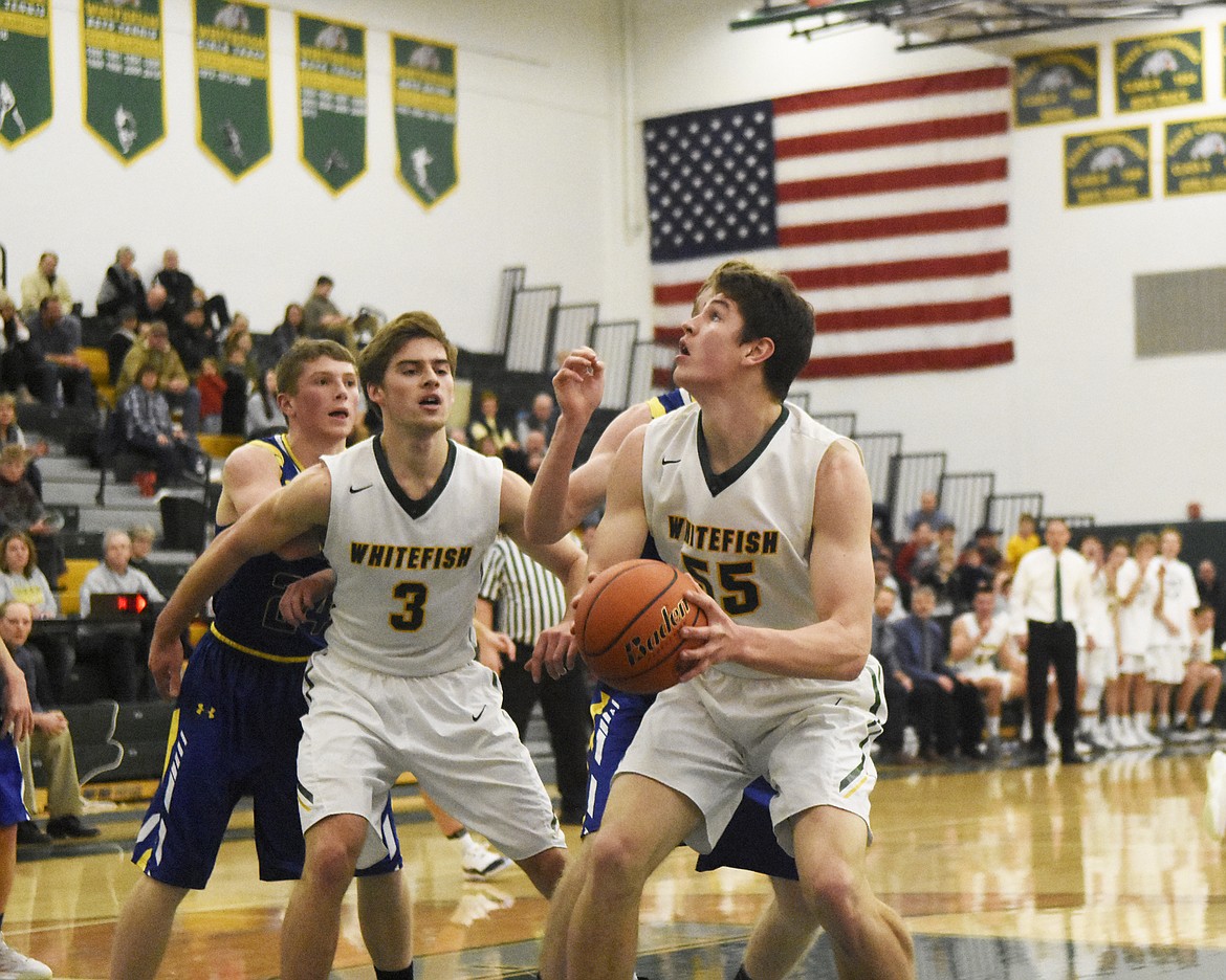 Dillon Botner cleans up a play in the post in Friday&#146;s home win over Libby. (Daniel McKay/Whitefish Pilot)