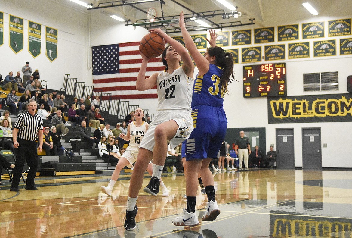 Jadi Walburn soars for the layup during Friday's home loss to the Lady Loggers. (Daniel McKay/Whitefish Pilot).