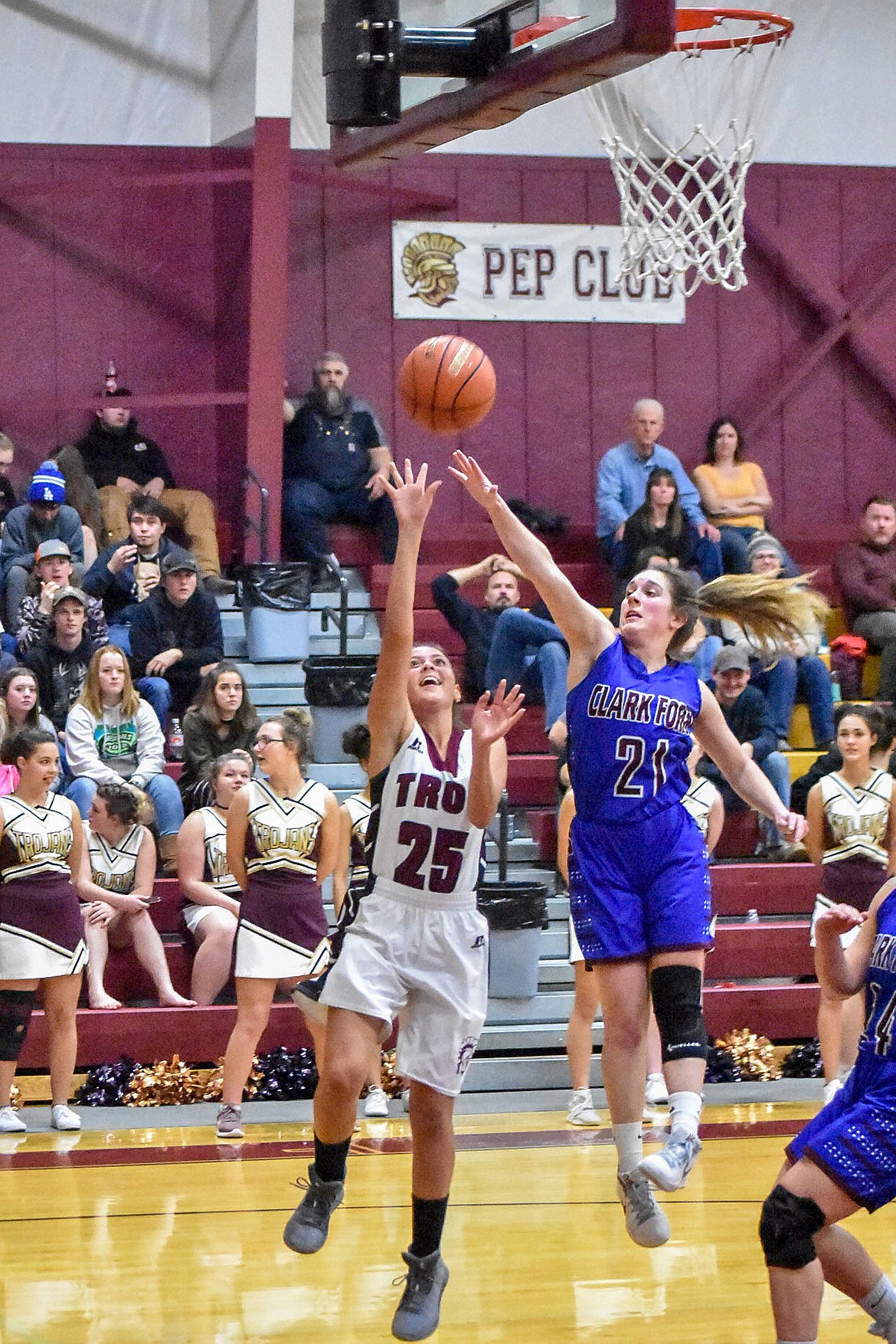 Troy junior Izzy Ramirez, with the Clark Fork defenders barely catching up to her, makes a layup late in the first quarter to make the score 12-8, Troy, late in the first quarter Dec. 3. (Ben Kibbey/The Western News)