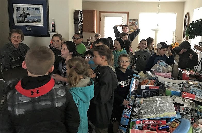 Superior&#146;s fourth-grade class delivered gifts to Women in Timber&#146;s Linda Christofferson. The gifts will be added to baskets delivered to families in need by the Lions Club. (Photo courtesy of Mrs. Crabb)