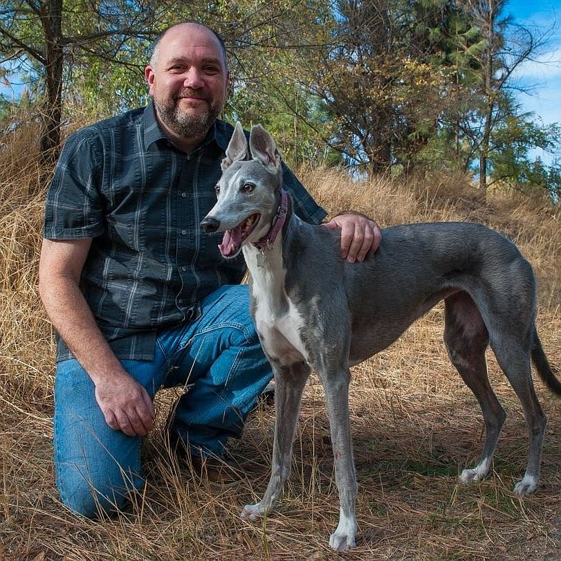 Tim Devine with Tutu, a greyhound he lost to bone cancer a few years ago.